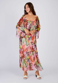 Long, colorful dress made of sheer fabric with floral prints in pink, green, and yellow; features a smocked bodice and flowing sleeves.