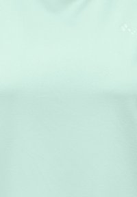 Tessuto verde menta chiaro con sottili impronte di zampe in rilievo nell'angolo in alto a destra.