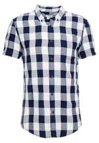Camicetta a maniche corte con bottoni in tessuto a quadri blu navy e bianco, con una tasca sul petto e un colletto strutturato. Tessuto misto cotone.