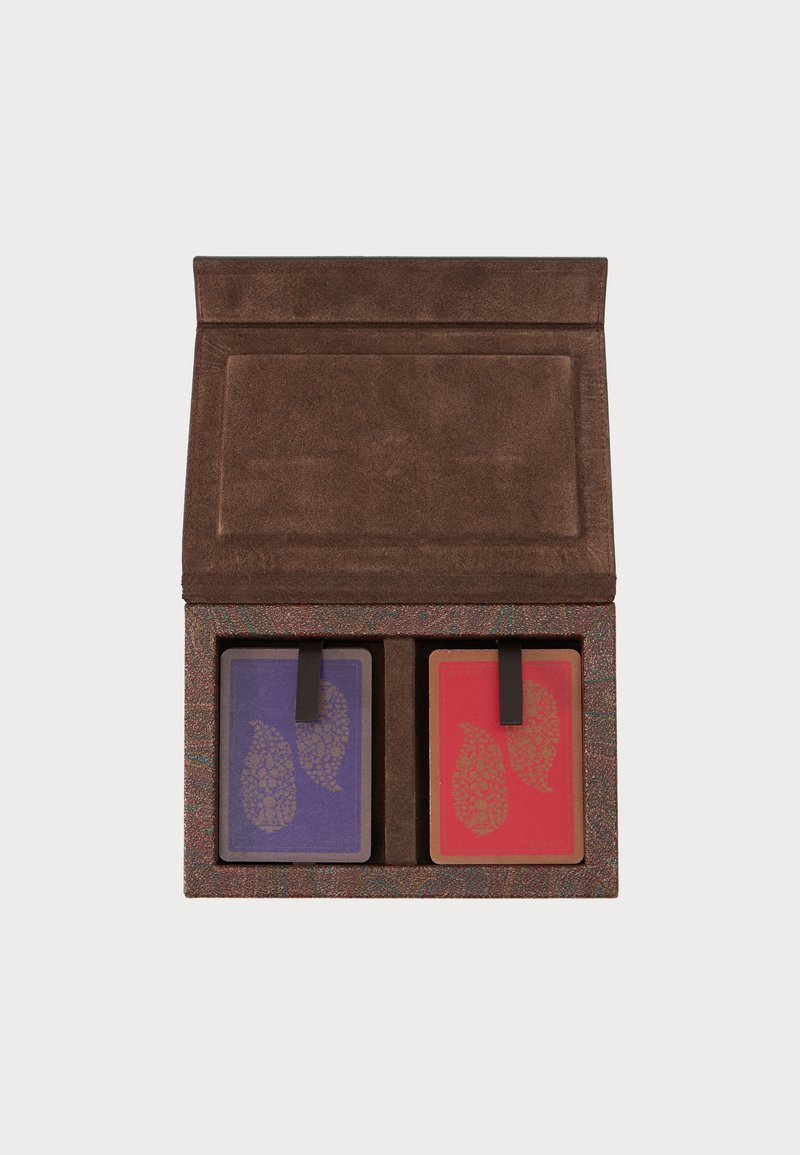 Brown suede case holding two decks of playing cards with purple and red backs, each featuring a gold paisley design and black pull tabs.