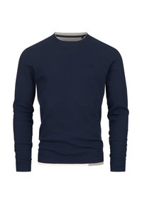 Marineblauw T-shirt met lange mouwen in geribbelde textuur met een ronde hals en een lichtkleurige afwerking bij de kraag en zoom.