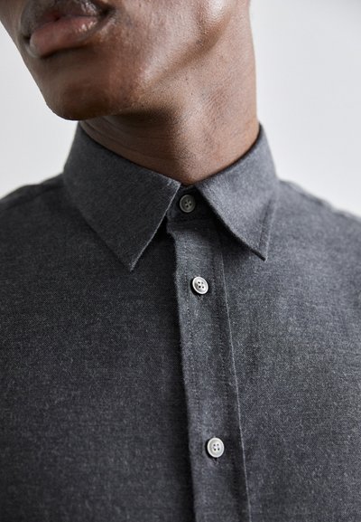 Gray button-up shirt with a textured fabric, point collar, and four visible buttons. The shirt features a slim fit design, accentuating the neck area.