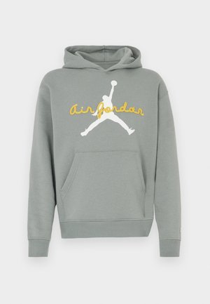Szürke kapucnis pulóver puha anyagból, fehér sziluett grafikával és sárga "Air Jordan" felirattal az elején. Kenguruzsebbel ellátva.
