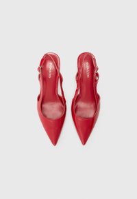 Red patent leather slingback pumps with pointed toes, a glossy finish, and a buckle accent on the side. Smooth interior lining.