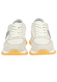 Pair of white sneakers with beige suede accents, gray details, white laces, and bright orange rubber soles, viewed from the front.