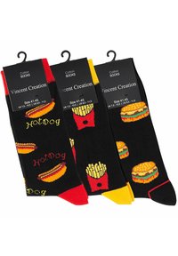 Trois paires de chaussettes en coton avec un fond noir et des motifs colorés sur le thème de la nourriture : hot-dogs, frites et hamburgers. Chacune a des accents distincts.