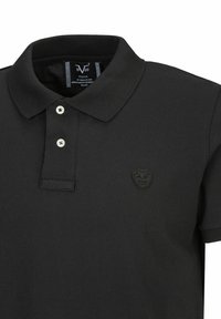 Zwarte poloshirt van gestructureerde katoen, met een drieknoopsluiting, subtiele logo-borduring en een klassiek kraagontwerp.