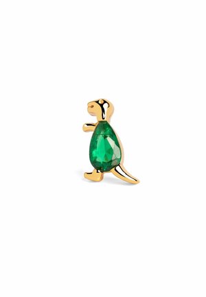 Épingle en forme de dinosaure en or avec une grande pierre précieuse verte comme corps, debout sur un fond blanc.