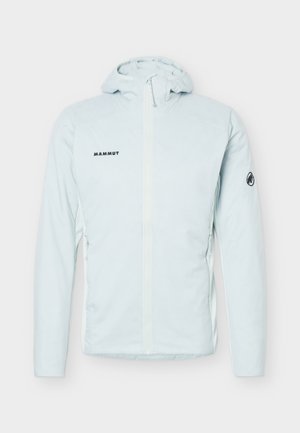 Veste à capuche bleu clair avec fermeture éclair devant, logo Mammut sur la poitrine et emblème de mammouth sur la manche gauche.