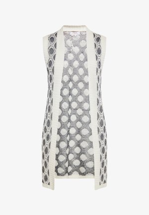 Kreemjas ja tumesinises toonis ilma varrukateta kootud kardigan avatud ees, millel on kangal ringilised mustrid. Tekstuuriga kootud, kontrastsete servadega.