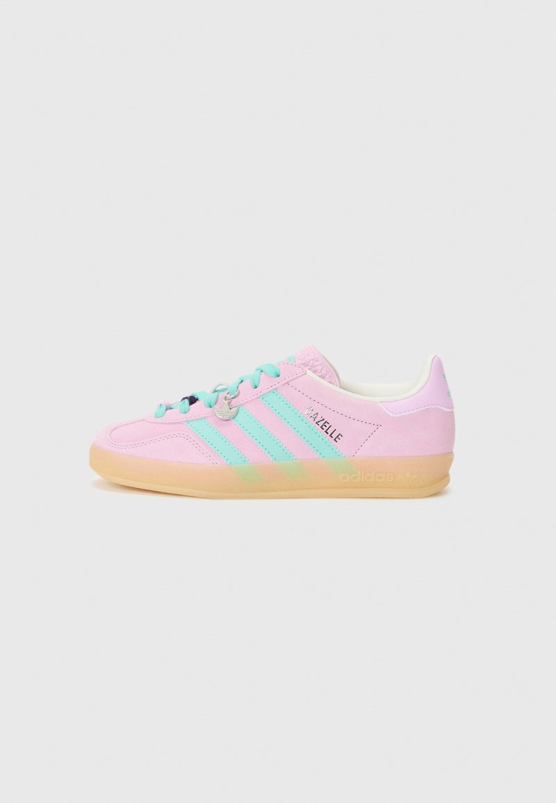 Pink suede sneaker with light blue accents, three striped design, tonal stitching, and a gum sole. Features a classic lace-up closure.