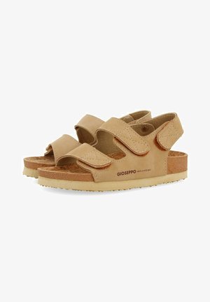 Sandalias beige con correas de Velcro ajustables dobles, plantilla de corcho texturizado y suela de goma; cuenta con detalles de costura y logotipo.