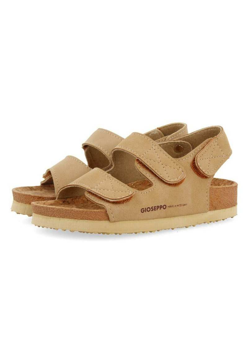 Sandalias beige con correas de Velcro ajustables dobles, plantilla de corcho texturizado y suela de goma; cuenta con detalles de costura y logotipo.