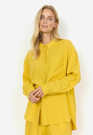 Yellow button-up shirt made of lightweight fabric, featuring a collared neckline, long sleeves, and a chest pocket with a relaxed fit.