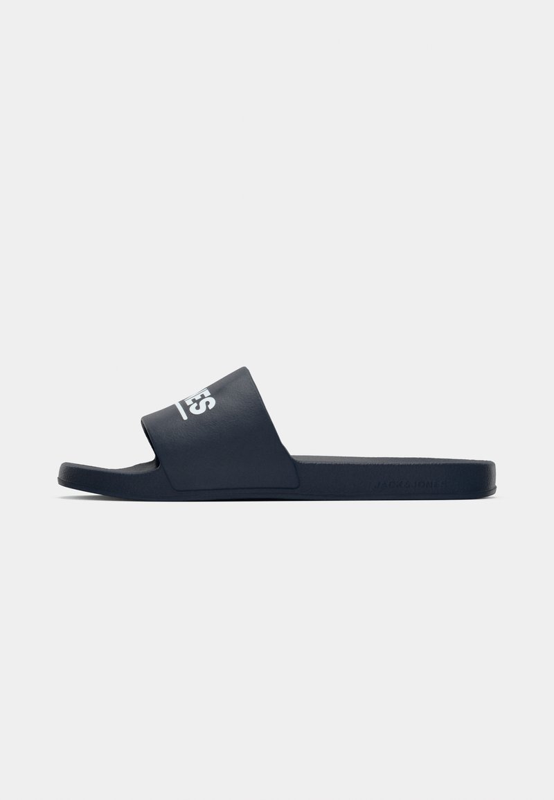 Navy slide sandal with a wide strap and white logo. Made of soft, durable material with a flat sole and textured footbed for grip.