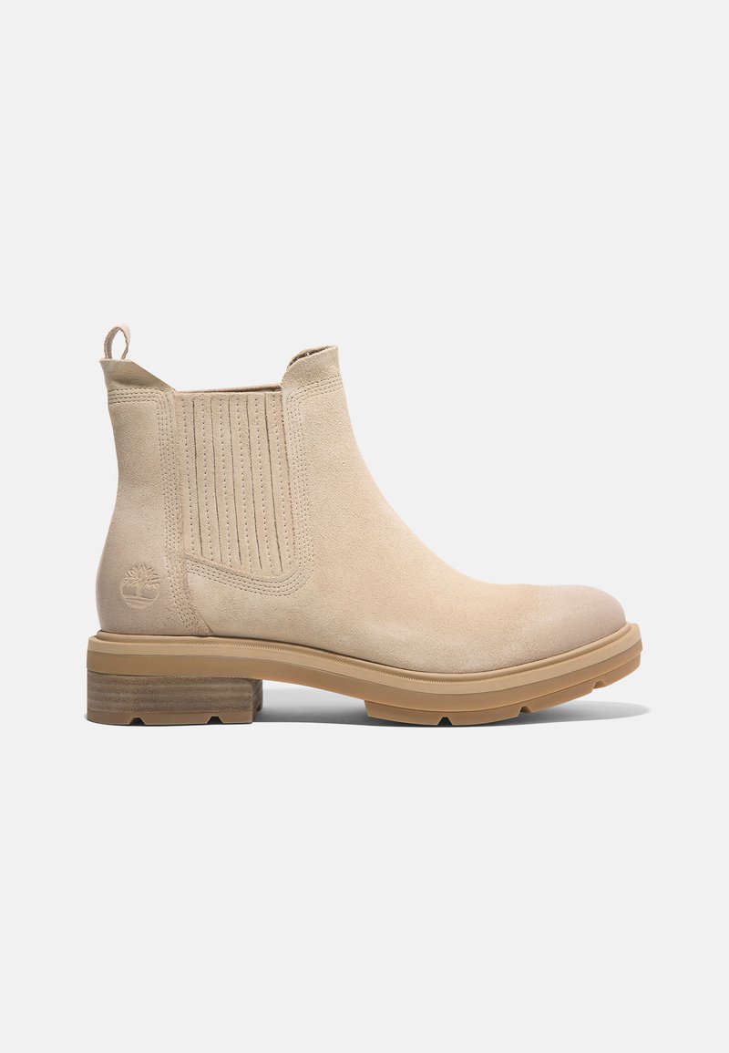 Bottine en suède beige avec des panneaux élastiques sur les côtés, un bout arrondi et une semelle en caoutchouc. Comprend un petit logo sur le talon et une languette à l'arrière.