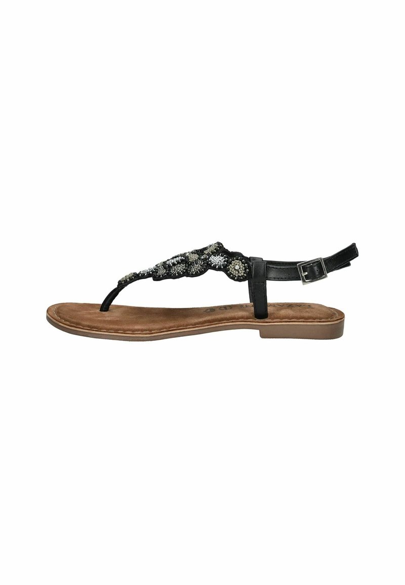 Sandalo nero con cinturino a thong, decorato con dettagli intrecciati e accenti in argento, cinturino alla caviglia regolabile e soletta in suede marrone. Suola piatta.