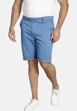 Light blue cotton shorts with a button closure, angled side pockets, and a gray checkered cuff. Paired with white sneakers.