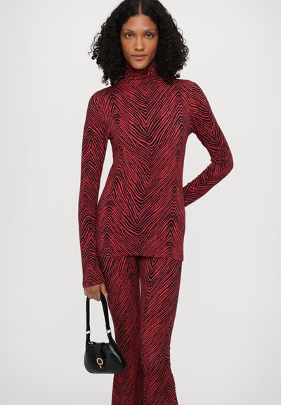 Stieglitz MISO FLARED LEGGINGS - Leggings - Trousers - red