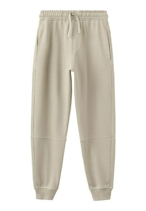 Pantalon de jogging beige avec taille élastique, cordon de serrage, poches latérales, empiècements cousus aux genoux et poignets côtelés aux chevilles.