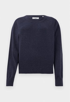 Pull bleu marine en tissu tricoté doux, avec un col rond, des manches longues et des détails en bord-côte. Accents de couture subtils supplémentaires.