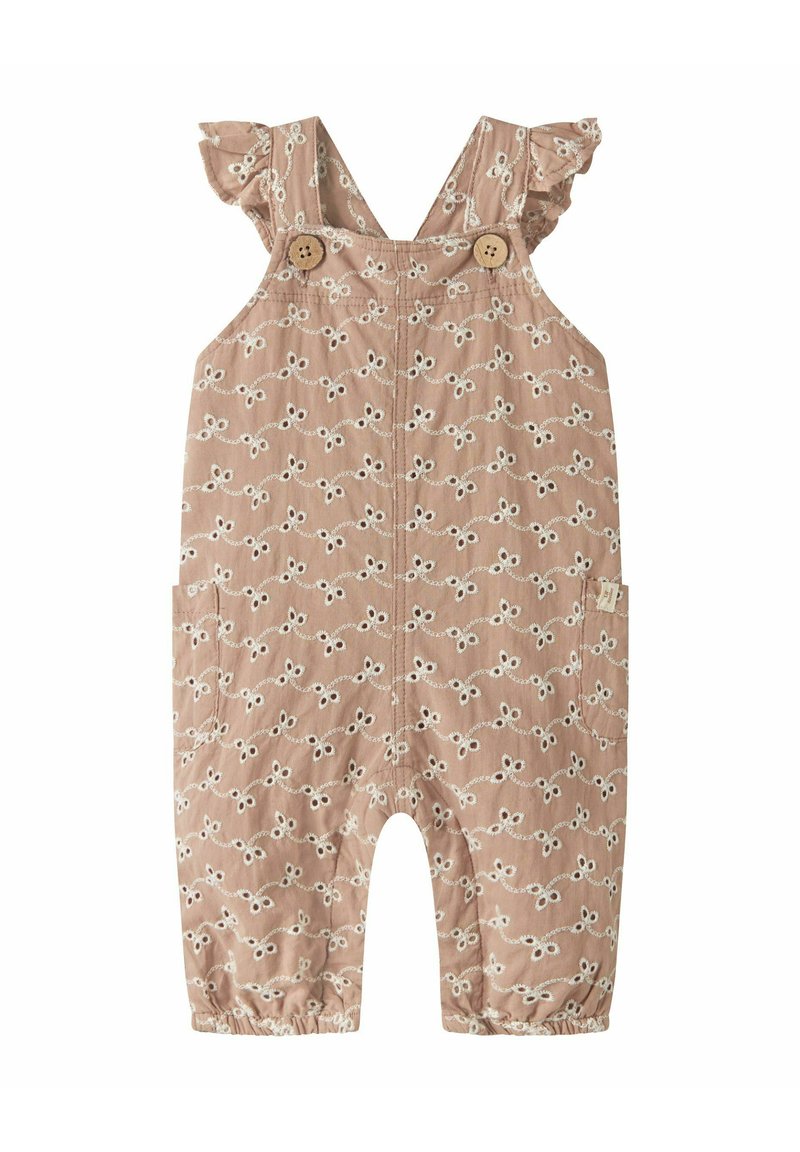 Smėlio spalvos kombinezonas su baltais gėlių siuvinėjimais, raukšlėtomis petne�šėlėmis, mediniais mygtukais ir elastinėmis rankogaliais. Komplekte yra šoninės kišenės ir laisvas siluetas.