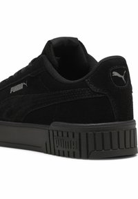 Crne nubuk tenisice s podstavljenim jezikom, teksturiranim crnim gumenim potplatima i srebrnim Puma logom s bočne i stražnje strane.
