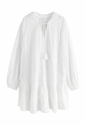 White, long-sleeve blouse with a tiered hem, featuring floral embroidery, a keyhole neck with a tie, and textured fabric.