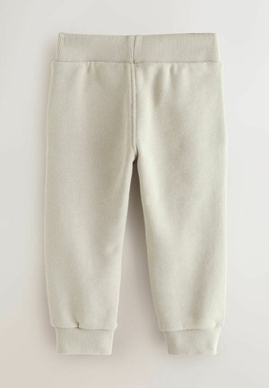 Pantaloni sport de culoare gri deschis cu o talie și manșete striate. Confecționați dintr-un material texturat cu o finisare netedă, potriviți pentru purtarea casual.