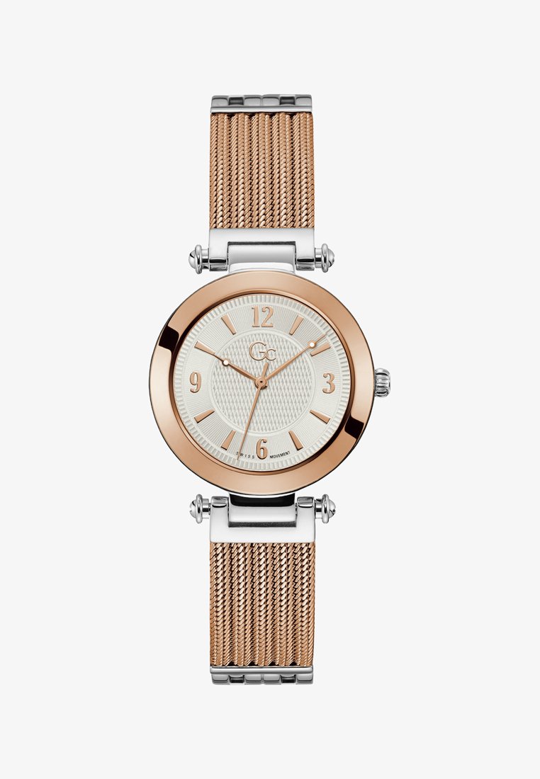 Roosa kullaga ja hõbedast võrklint, ümmargune korpus, tekstureeritud valge täpp ja roosa kullast tunniindikaator. Šveitsi mehhanism.