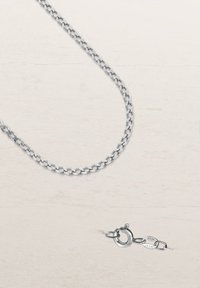 Silver chain necklace featuring oval links and a lobster clasp closure, with a smooth texture and shiny finish.