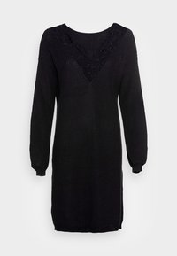 Abito lavorato a maglia nero con maniche lunghe, scollatura a V arricchita da dettagli in pizzo, texture a coste e spacchi laterali per facilitare i movimenti.