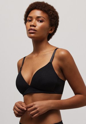 Bralette triangular de algodón negro con tirantes ajustables. Textura suave, diseño de cuello en V y banda elástica inferior para un ajuste seguro. Estilo minimalista.
