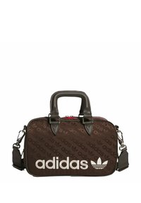 Brown fabric bag featuring repeating adidas logo pattern, leather accents, dual top handles, and a detachable shoulder strap. Red zipper detail.