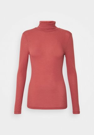 Rustfarvet, ribstrikket højhalset top med lange ærmer og tætsiddende silhuet på en ensartet lys baggrund.