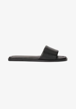 Black slide sandals featuring a wide, smooth strap and a flat sole. Made from a sleek material with a minimalistic design.