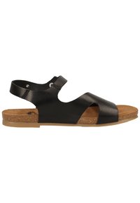 Infradito in pelle nera con cinturino alla caviglia regolabile, soletta in sughero e design minimalista. Presenta una texture liscia e suola piatta.