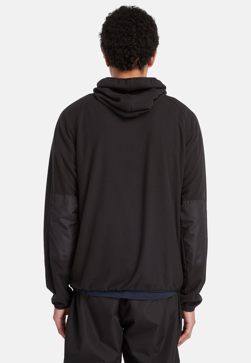 Zwarte hoodie met een gestructureerd lichaam, gladde mouwen en elastische manchetten. Voorzien van een trekkoordcapuchon en ademende stof.