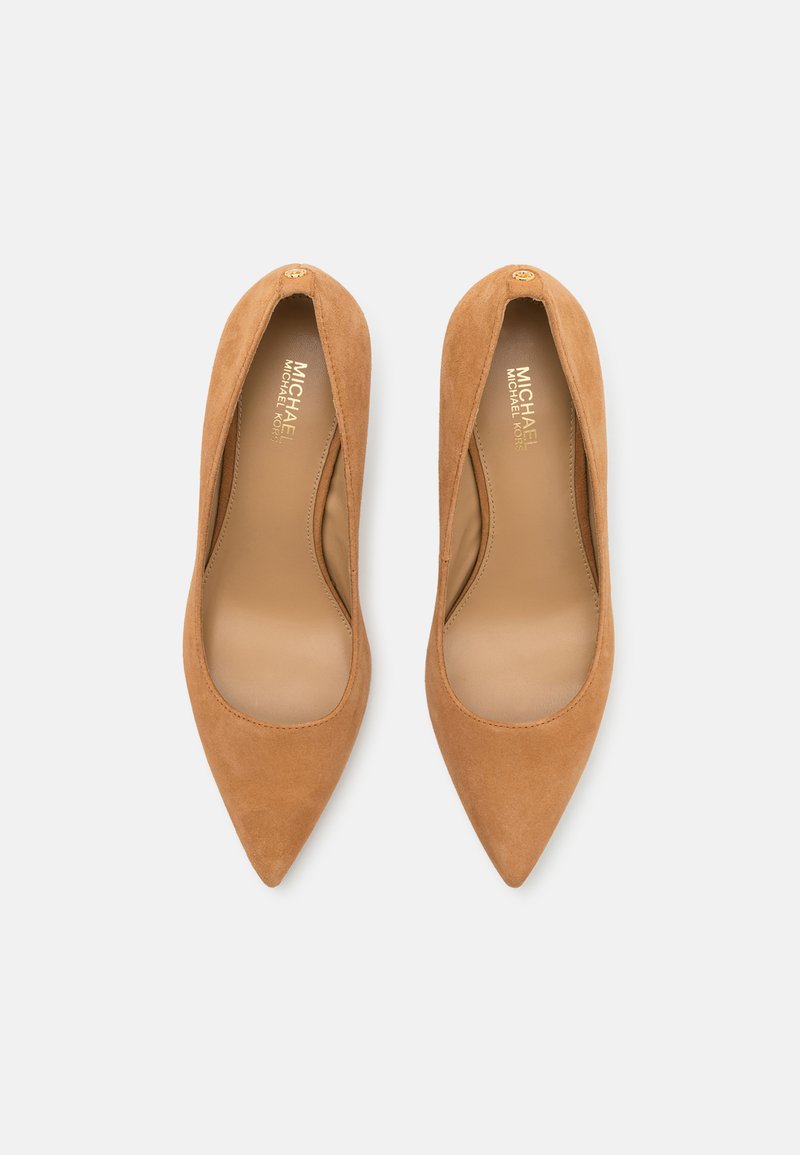 Escarpins hauts en suède beige avec un bout pointu, doublure intérieure lisse et un accent en logo doré près du talon.