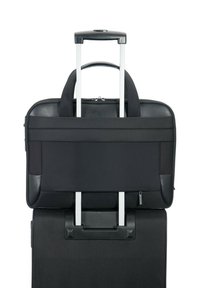 Black rolling laptop bag featuring a padded design, two top handles, and a telescopic handle for easy transport. Smooth fabric and sturdy hardware.