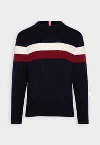 Pull en maille côtelée bleu marine avec des rayures horizontales blanches et rouge foncé sur la poitrine et les manches longues.