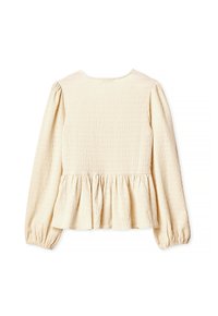 Kermanvärinen peplum-toppi, jossa on pitkät hihat, gatheroitua tekstuuria ja pyöreä pääntie. Pehmeä kangas, joka laskeutuu kauniisti, ja joustavat hihansuut.