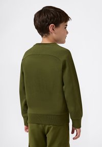 Grön sweatshirt med rund halsringning, ribbade ärmslut och nederkant. Har en mjuk textur och en ren, minimalistisk design.