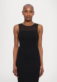 Black sleeveless dress with a sheer mesh panel at the neckline, solid fitted design, and smooth jersey fabric. Simple and elegant silhouette.