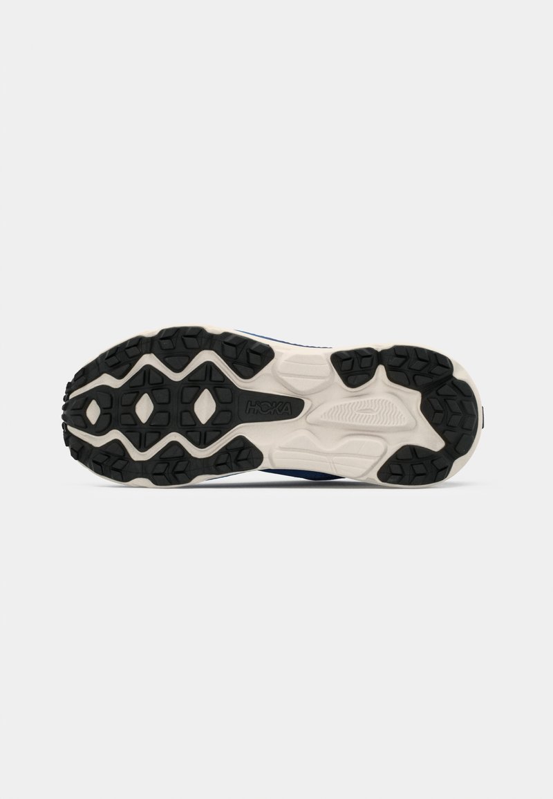 Black rubber outsole with treads; white midsole; features a smooth, durable finish; shaped for comfort and stability.