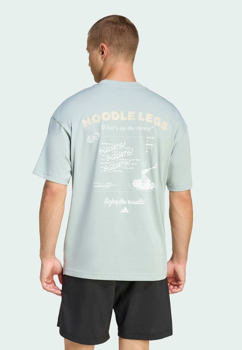 Light blue short-sleeve t-shirt with printed white graphics on the back, featuring text and illustrations related to squats and fitness.