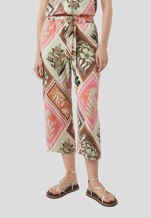Patterned cropped pants in vibrant colors, featuring floral designs, a drawstring waist, and a lightweight fabric. Paired with strappy sandals.