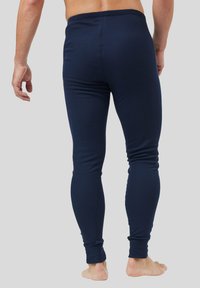 Navy blue leggings with a fitted design, elastic waistband, and tapered legs, made from a soft, stretchable material.