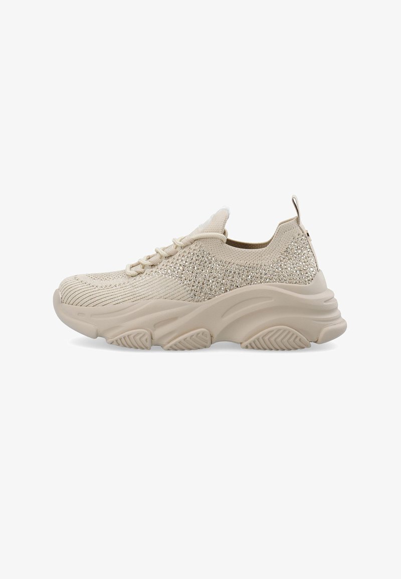 Beige athletic shoes with a textured knit upper, embellished with rhinestones, and thick rubber sole with grooves for traction.