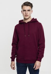 Maroons Hoodie aus weichem Stoff, mit einer großen Fronttasche, Kapuze mit Kordelzug und gerippten Bündchen im schlichten Design.